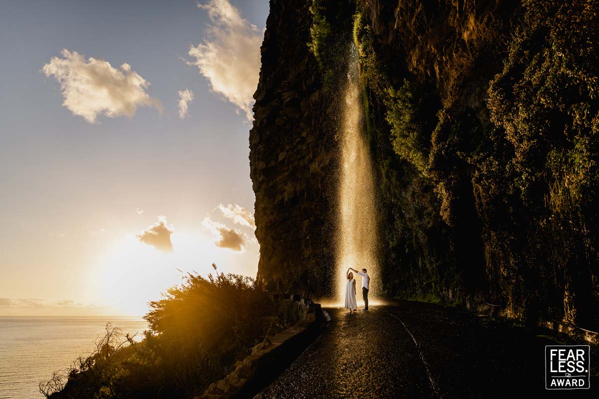 Photo of couple at sunset next to Anjos Waterfall in Madeira Island, Portugal.