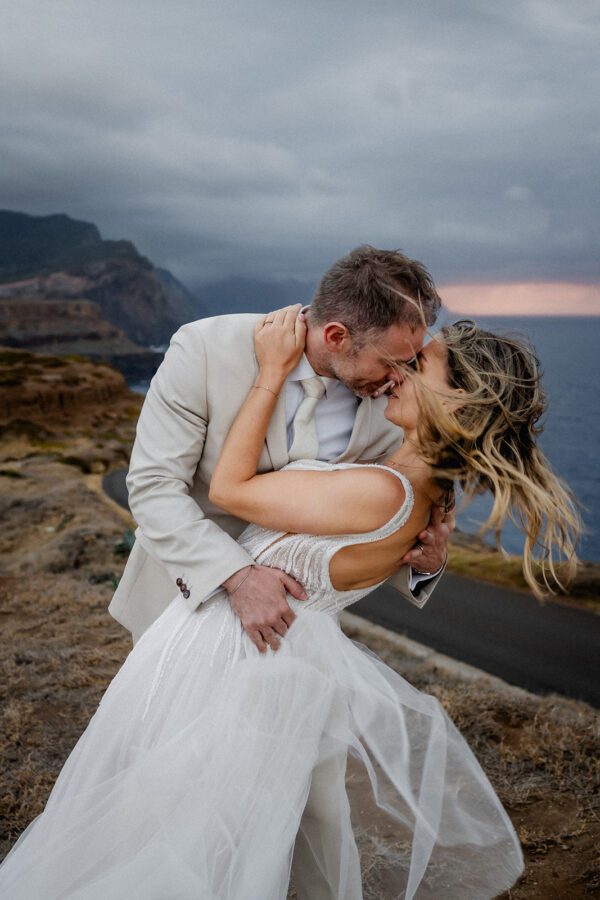 Bride and groom embracing in the mountains near São Lourenço in Madeira Islanda during a dramatic destination wedding session in Madeira.