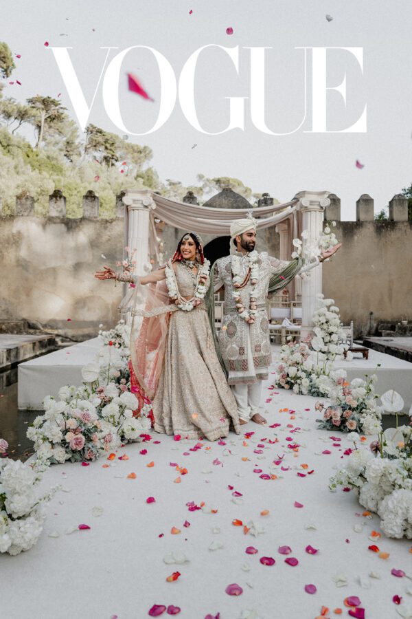 Vogue featured Indian wedding ceremony at Penha Longa, Sintra with floral decor and a joyful couple celebration.
