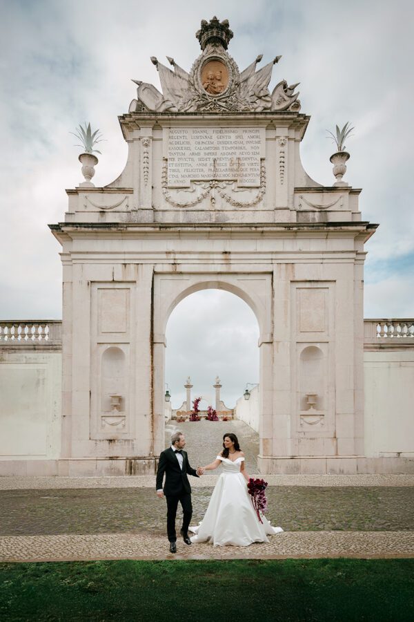 Bride and groom walking in Seteais Palace, in Sintra, during a destination wedding in Portugal.