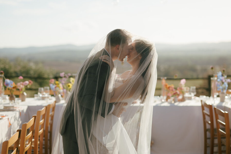 Bride and groom under the veil during their destination wedding in Tuscany, Italy