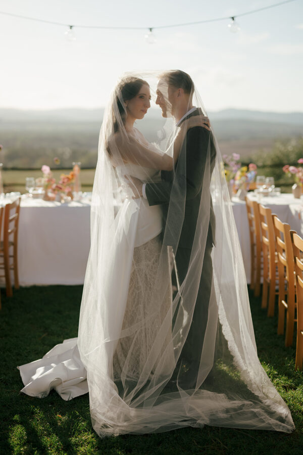 Bride and groom under the veil at a destination wedding in Tuscany, Italy